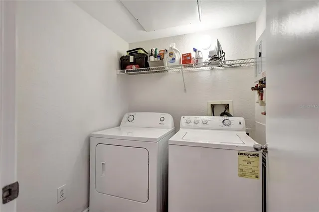 a view of storage and utility room with washer and dryer
