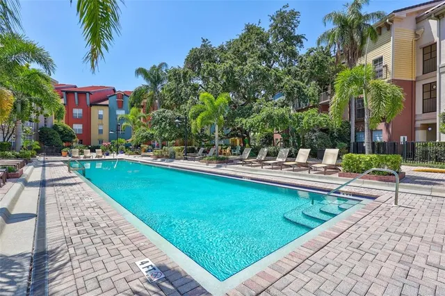 a swimming pool with outdoor seating and yard