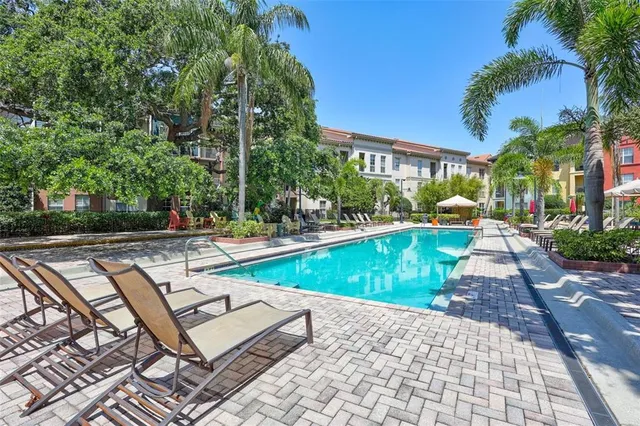 a swimming pool with outdoor seating and yard