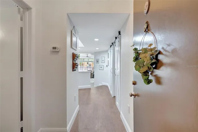 a view of a hallway with wooden floor