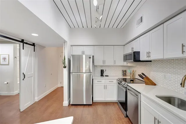 a kitchen with a refrigerator a sink and dishwasher