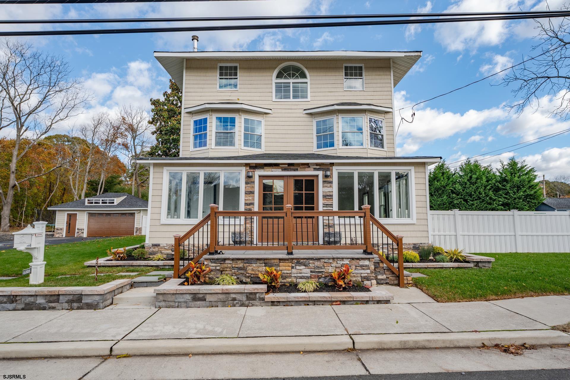 1203 West Mill Road Northfield, NJ 08225 - Photo 1 of 90 a front view of a house with a yard