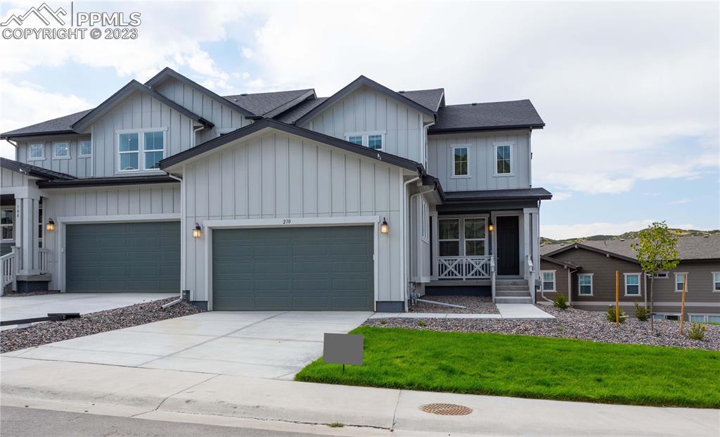 a front view of a house with a garden and plants