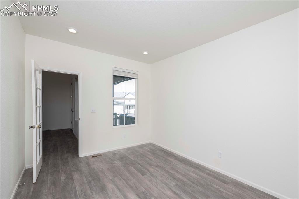 210 Felicity Loop Castle Rock, CO 80109 - Photo 3 of 27 an empty room with wooden floor and windows