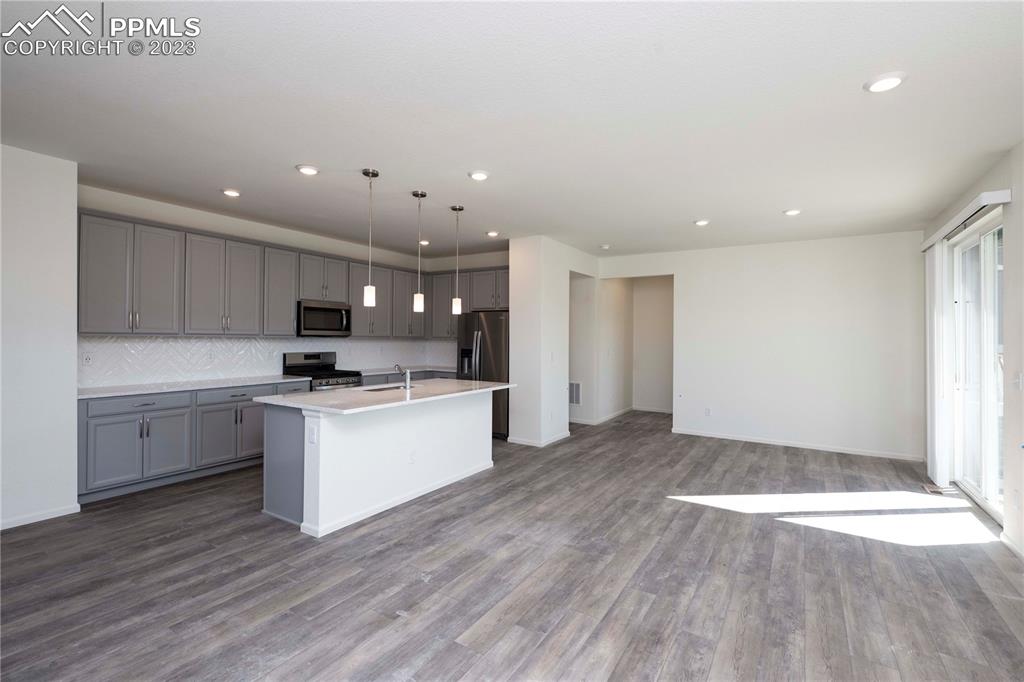 210 Felicity Loop Castle Rock, CO 80109 - Photo 8 of 27 a kitchen with a sink and wooden floor