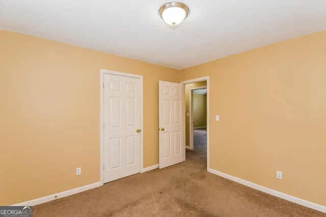 an empty room with closet area