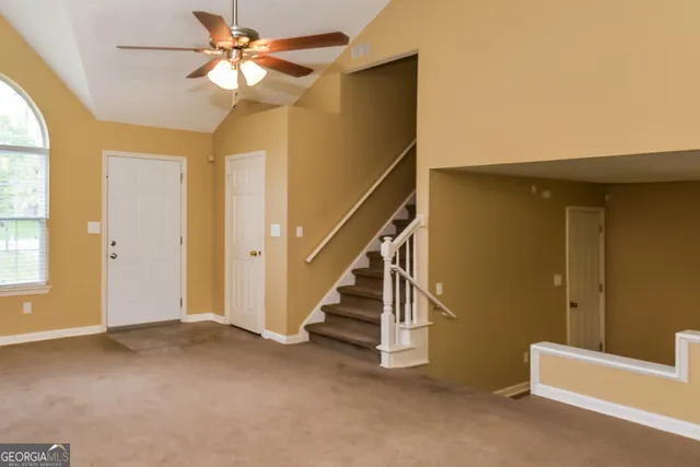 a view of entryway and hall with a ceiling fan