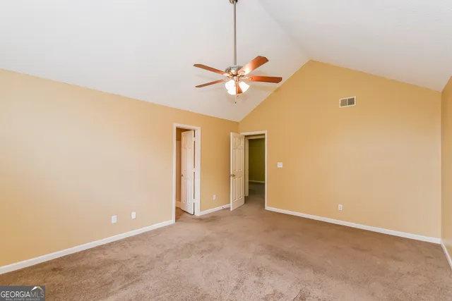a view of a room with a ceiling fan