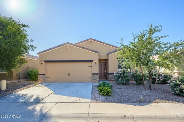a front view of house with garage and yard