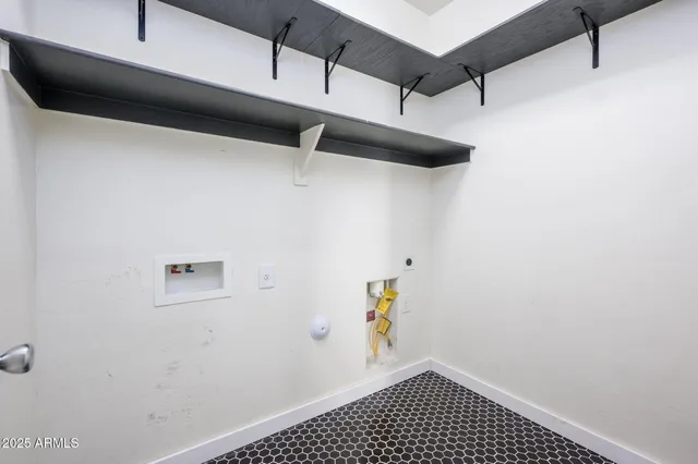 a view of storage and utility room with racks on the wall