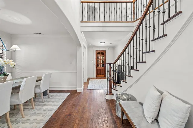 a view of entryway and hall with wooden floor