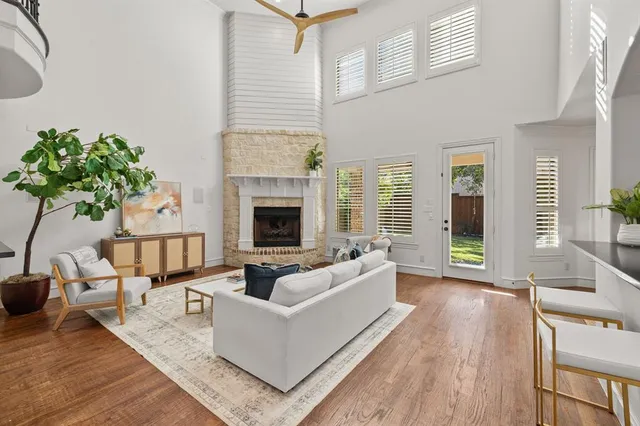a living room with furniture fireplace and potted plants