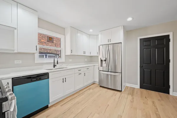 a kitchen with a refrigerator stove and sink