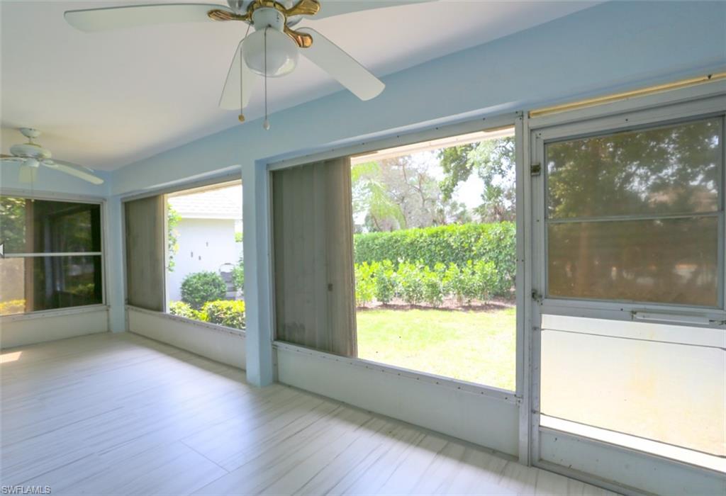 225 Georgetown Boulevard Naples, FL 34112 - Photo 18 of 37 Unfurnished sunroom with ceiling fan and lofted ceiling