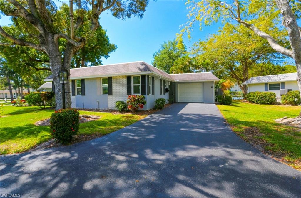 225 Georgetown Boulevard Naples, FL 34112 - Photo 2 of 37 Ranch-style house featuring a garage and a front lawn
