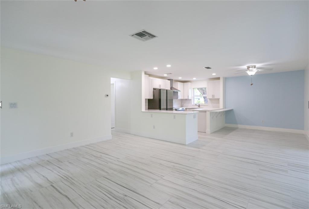225 Georgetown Boulevard Naples, FL 34112 - Photo 25 of 37 Unfurnished living room featuring sink and ceiling fan