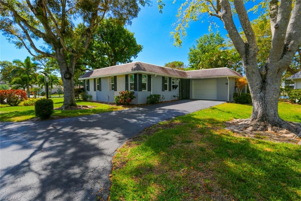 225 Georgetown Boulevard Naples, FL 34112 - Photo 3 of 37 Ranch-style house featuring a garage and a front yard