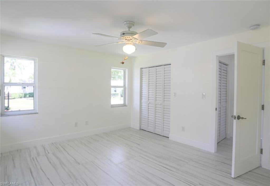 225 Georgetown Boulevard Naples, FL 34112 - Photo 32 of 37 Unfurnished bedroom with ceiling fan and multiple windows