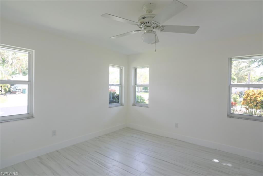 225 Georgetown Boulevard Naples, FL 34112 - Photo 35 of 37 Unfurnished room with ceiling fan and a wealth of natural light