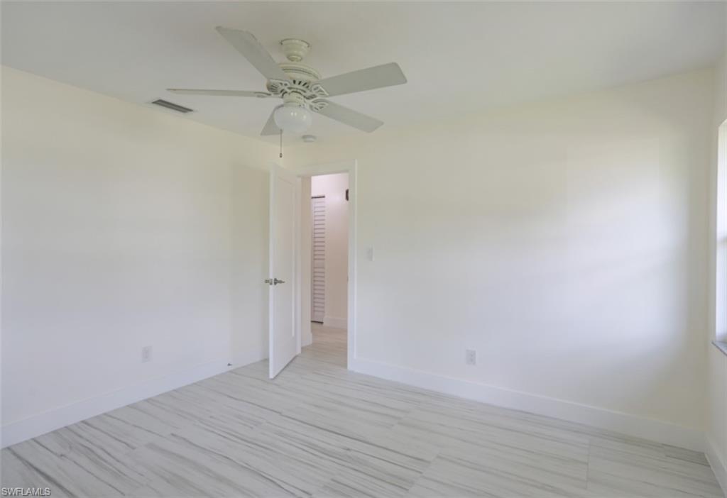 225 Georgetown Boulevard Naples, FL 34112 - Photo 36 of 37 Empty room with ceiling fan