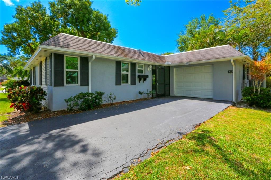 225 Georgetown Boulevard Naples, FL 34112 - Photo 7 of 37 Single story home with a garage and a front yard