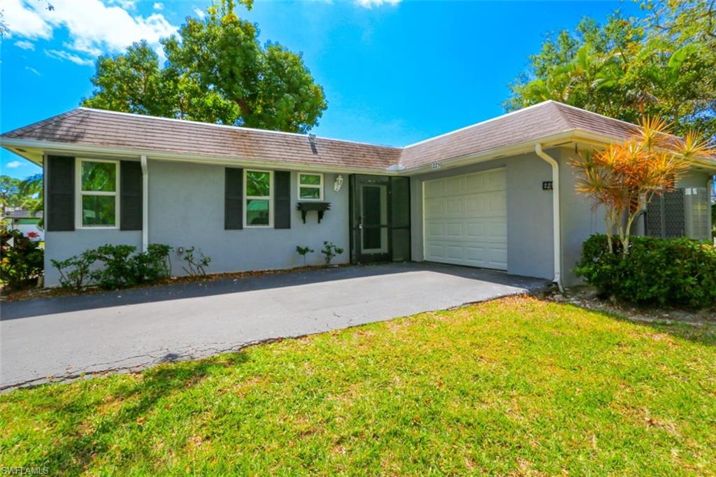 225 Georgetown Boulevard Naples, FL 34112 - Photo 8 of 37 Single story home with a garage and a front lawn