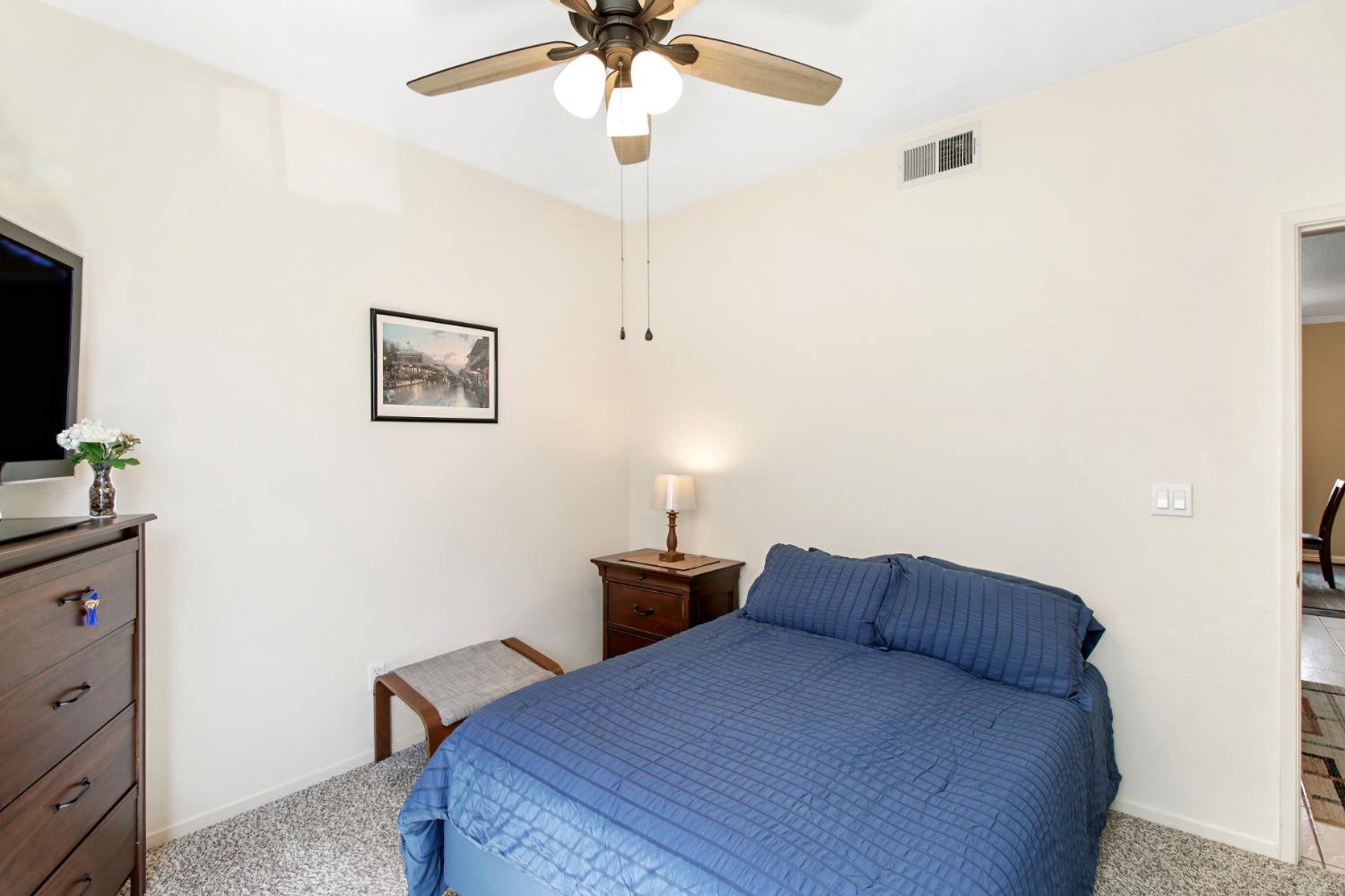 11568 Pyrites Court Gold River, CA 95670 - Photo 11 of 60 a bedroom with a bed and a flat tv screen on the wall