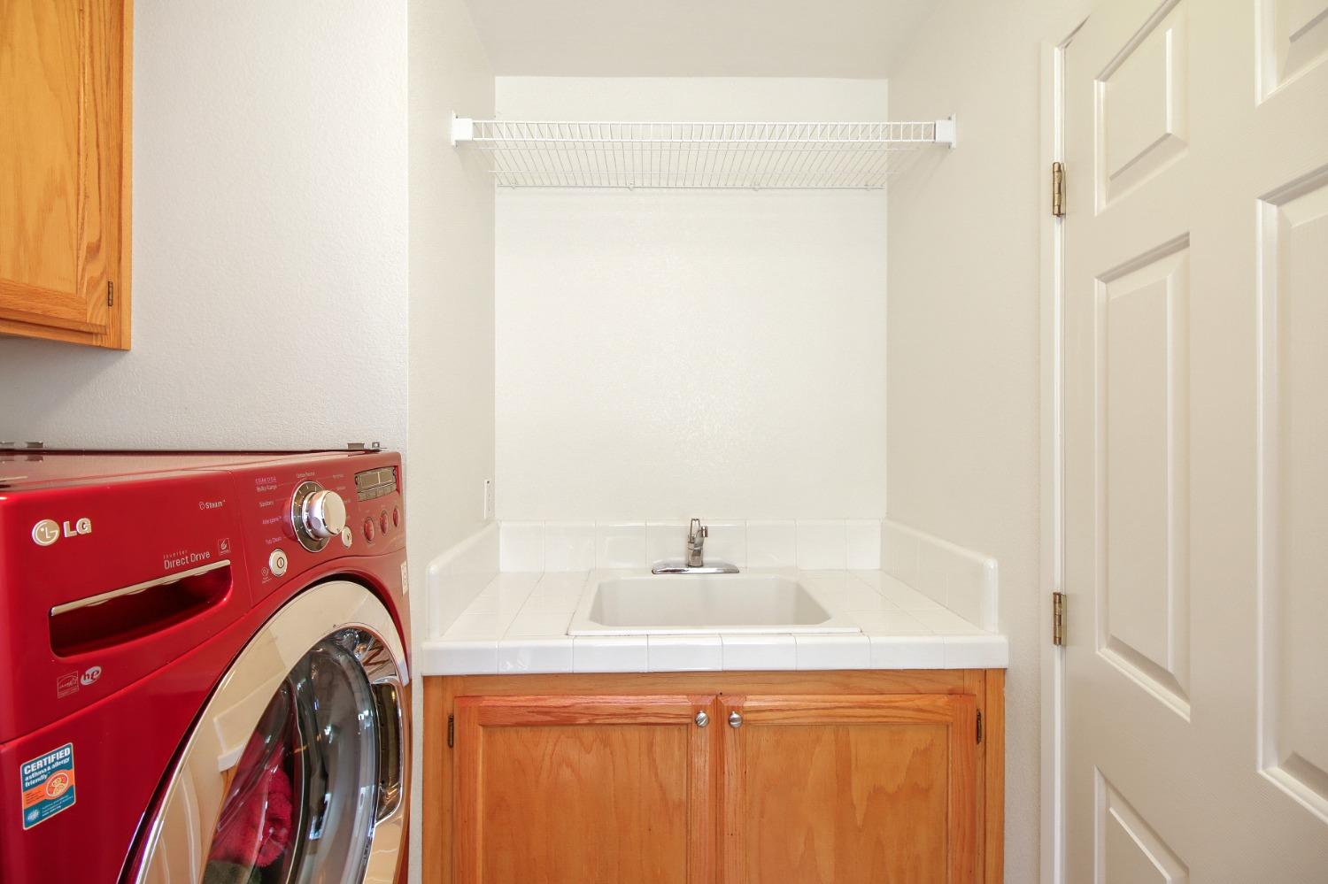 11568 Pyrites Court Gold River, CA 95670 - Photo 22 of 60 a utility room with a sink dryer and washer