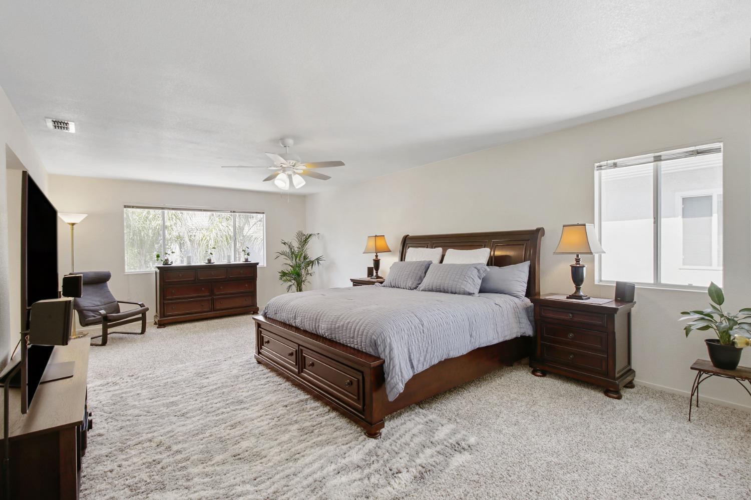 11568 Pyrites Court Gold River, CA 95670 - Photo 26 of 60 a spacious bedroom with a bed and window