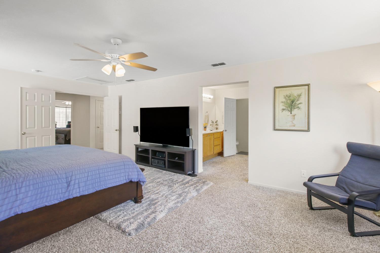 11568 Pyrites Court Gold River, CA 95670 - Photo 28 of 60 a bedroom with a bed and a flat screen tv