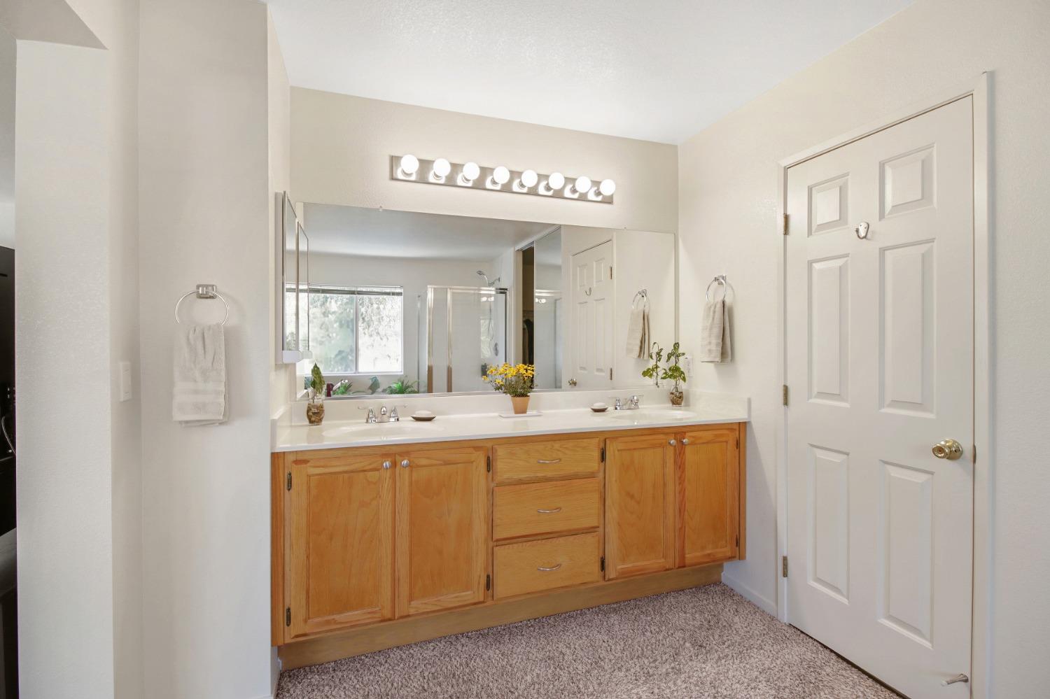 11568 Pyrites Court Gold River, CA 95670 - Photo 29 of 60 a spacious bathroom with a mirror a sink and a vanity