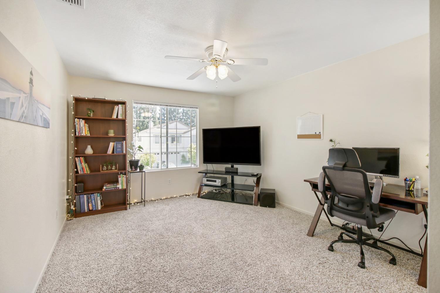 11568 Pyrites Court Gold River, CA 95670 - Photo 32 of 60 a living room with furniture and a flat screen tv