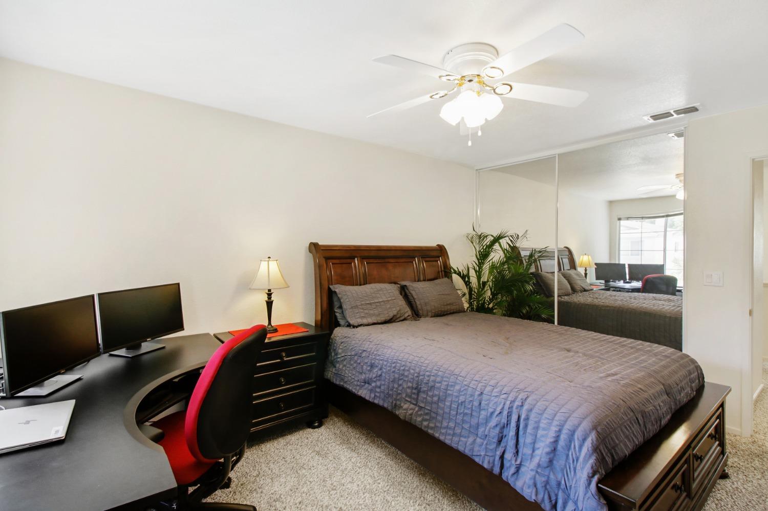 11568 Pyrites Court Gold River, CA 95670 - Photo 35 of 60 a bedroom with a bed and a chandelier