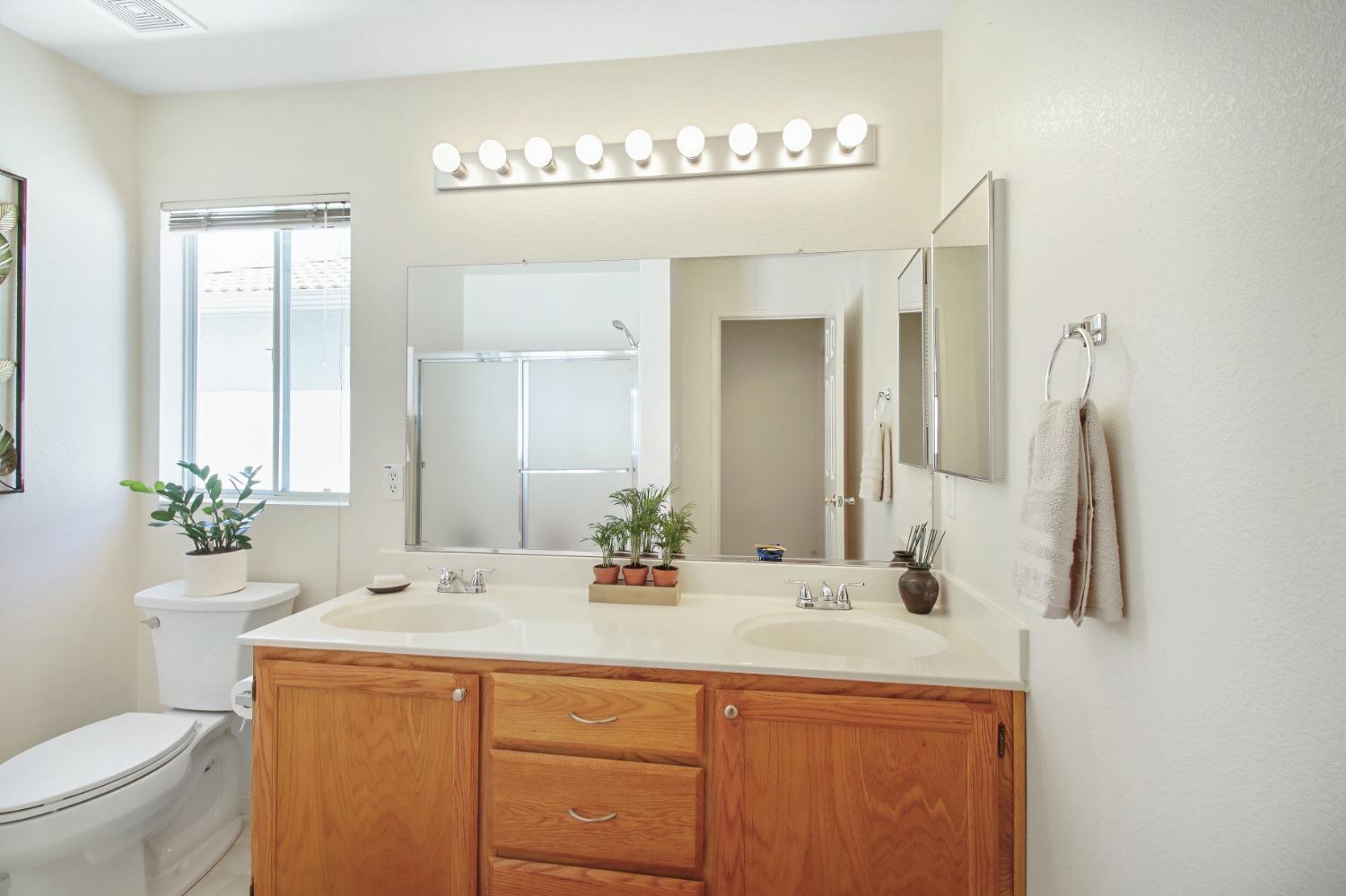 11568 Pyrites Court Gold River, CA 95670 - Photo 38 of 60 a bathroom with a double vanity sink and a mirror