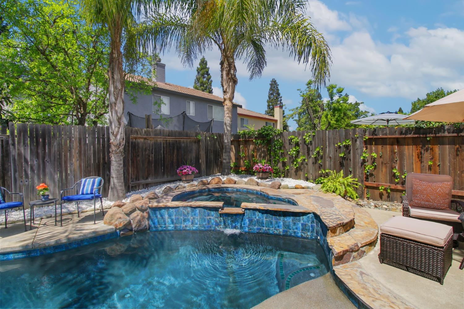 11568 Pyrites Court Gold River, CA 95670 - Photo 42 of 60 a swimming pool with outdoor seating and yard