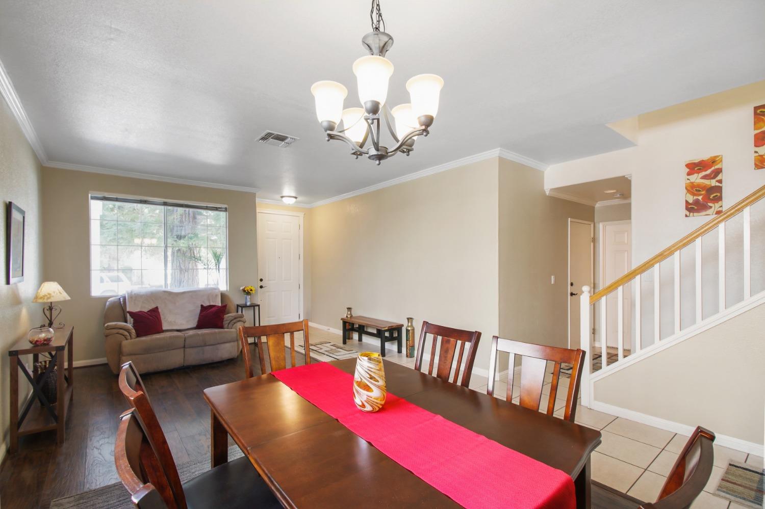 11568 Pyrites Court Gold River, CA 95670 - Photo 6 of 60 a living room with furniture chandelier and a large window