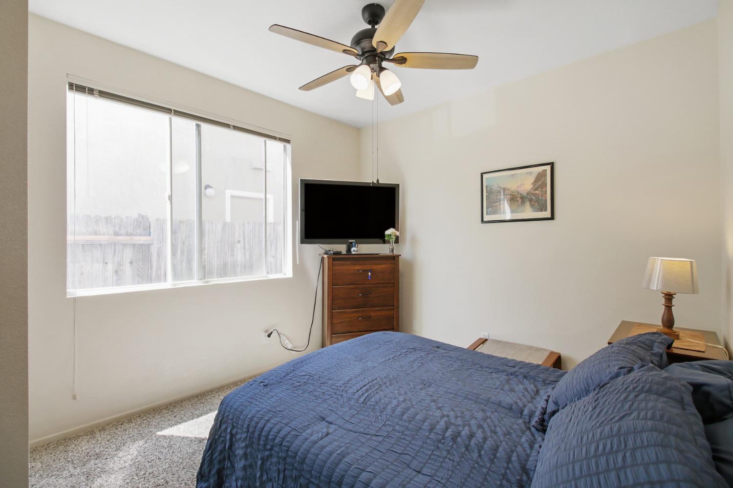 11568 Pyrites Court Gold River, CA 95670 - Photo 10 of 60 a bedroom with a bed and a flat screen tv