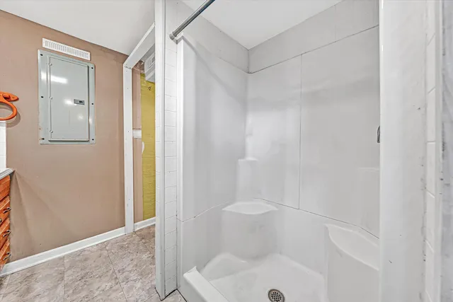 an empty room with wooden floor and a ceiling fan