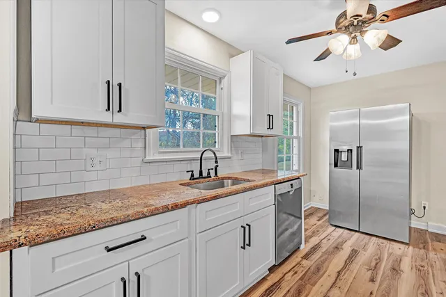 a view of a room with wooden floor closet and ceiling fan