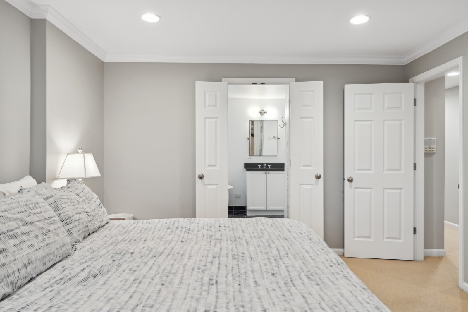 2027 North Howe Street, Unit 1 Chicago, IL 60614 - Photo 14 of 28 a bedroom with a bed and a mirror