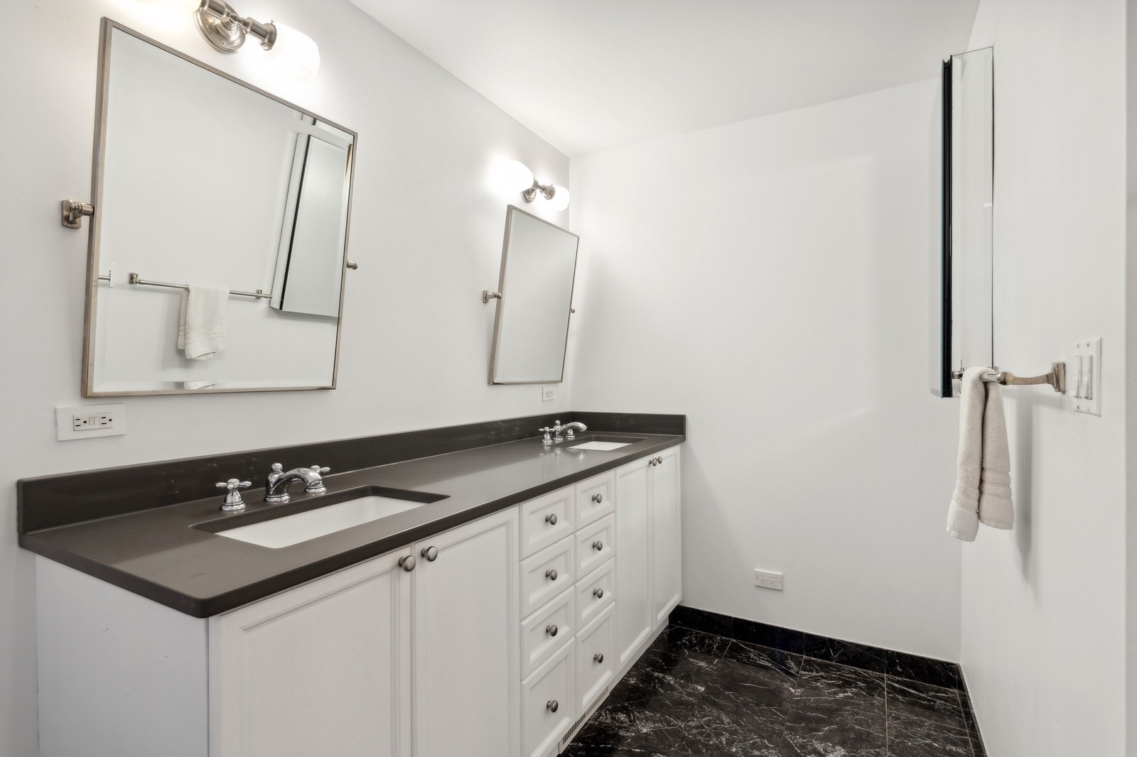 2027 North Howe Street, Unit 1 Chicago, IL 60614 - Photo 16 of 28 a bathroom with a sink and a mirror