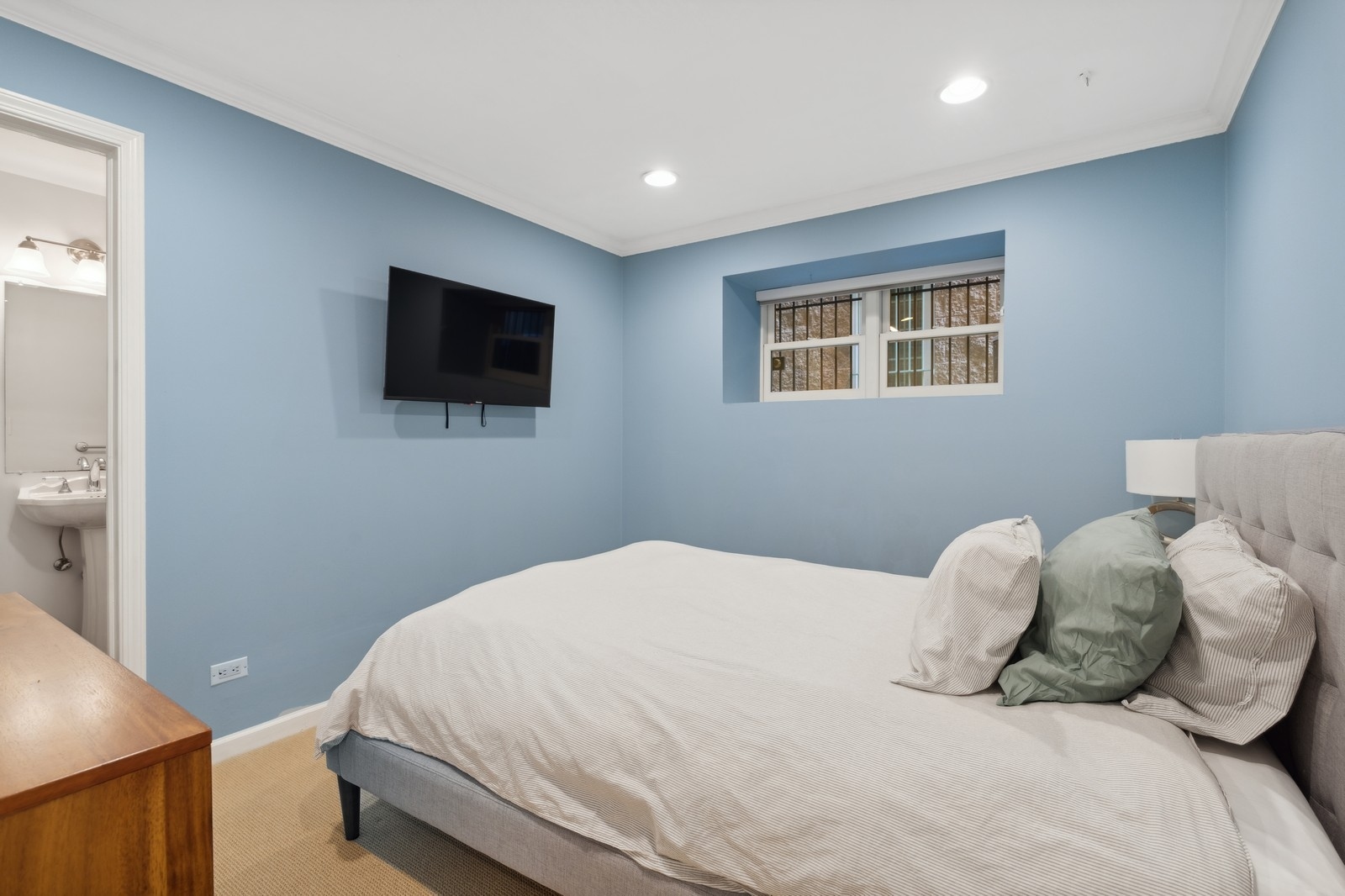2027 North Howe Street, Unit 1 Chicago, IL 60614 - Photo 19 of 28 a bedroom with a bed and a flat screen tv