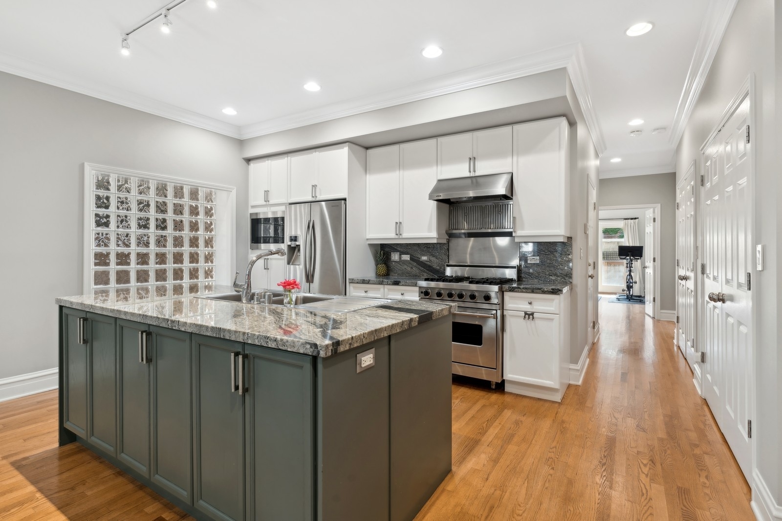 2027 North Howe Street, Unit 1 Chicago, IL 60614 - Photo 4 of 28 a kitchen with stainless steel appliances granite countertop a sink stove and refrigerator