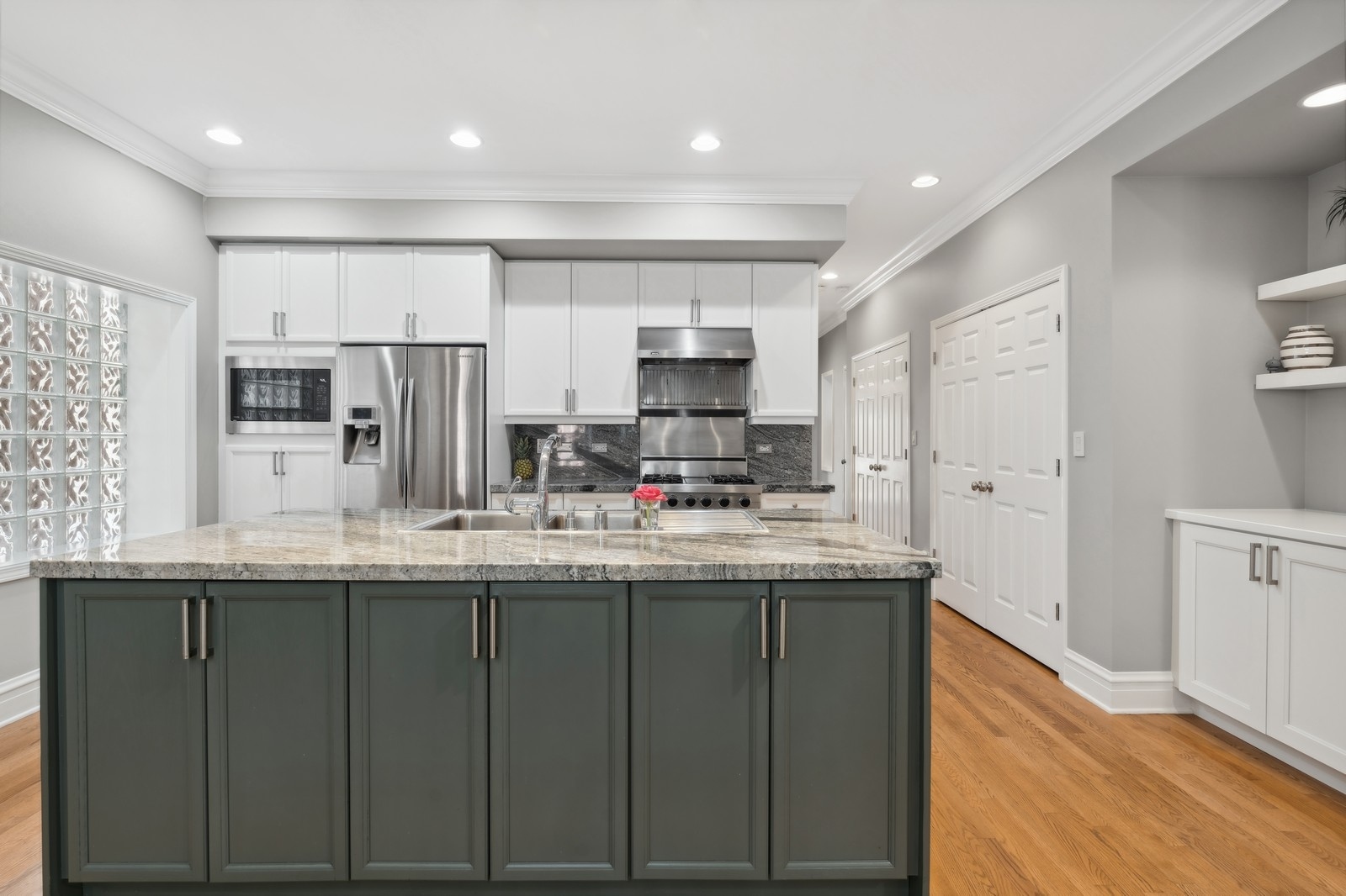 2027 North Howe Street, Unit 1 Chicago, IL 60614 - Photo 5 of 28 a kitchen with kitchen island granite countertop a sink and cabinets