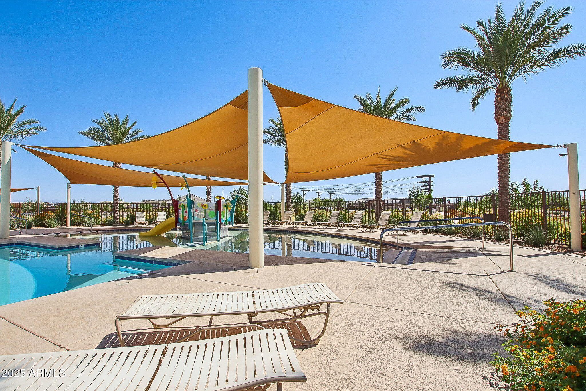 3935 East Ter Court San Tan Valley, AZ 85143 - Photo 8 of 15 a view of a swimming pool with a lounge chair and tables