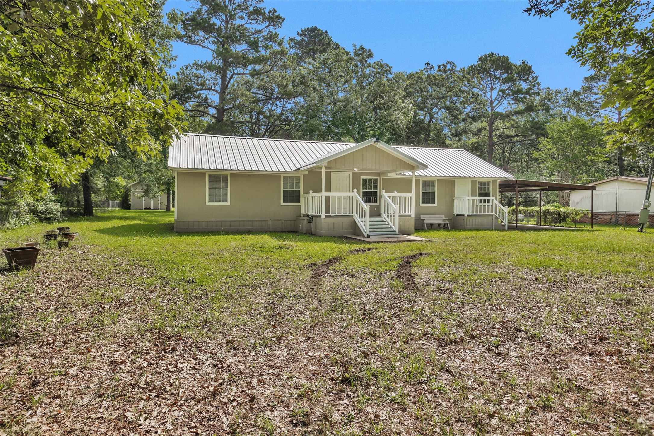 99 Main Street Huntsville, TX 77340 - Photo 3 of 47 Features an inviting patio area perfect for outdoor relaxation.
