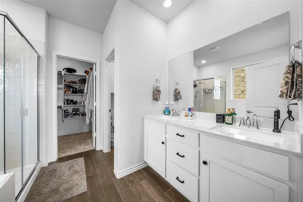 a spacious bathroom with a granite countertop sink and a mirror