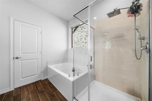 a bathroom with a bathtub and shower