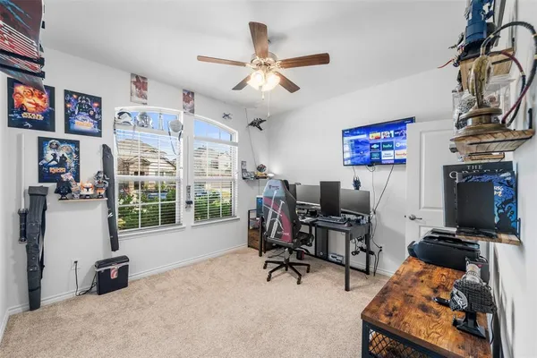 a view of a livingroom with workspace and a window