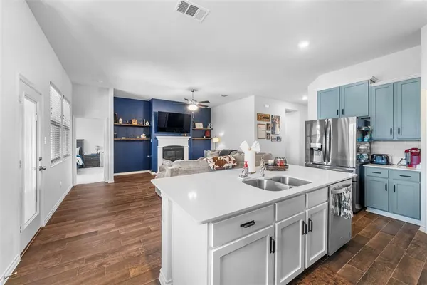 a kitchen with a sink stove and refrigerator